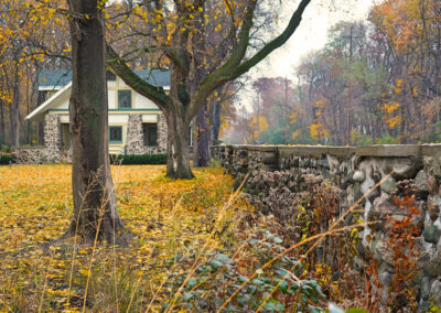 Road field stone wall, gatehouse in the distance